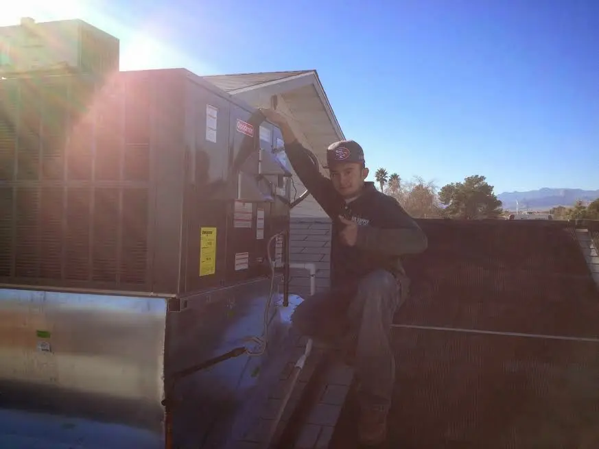 HVAC technician performing HVAC Inspection on a rooftop unit in Royse City